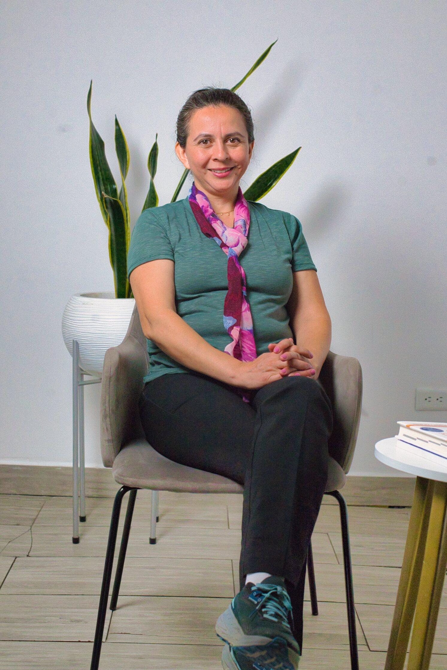 Pediatric therapist smiling in a bright clinical setting