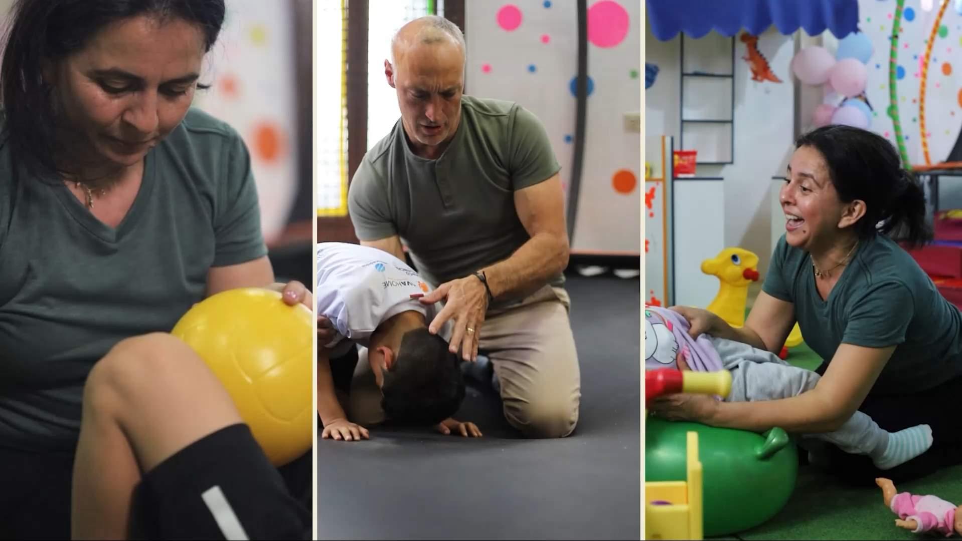 A pediatric therapist supporting a child during a playful physical therapy session