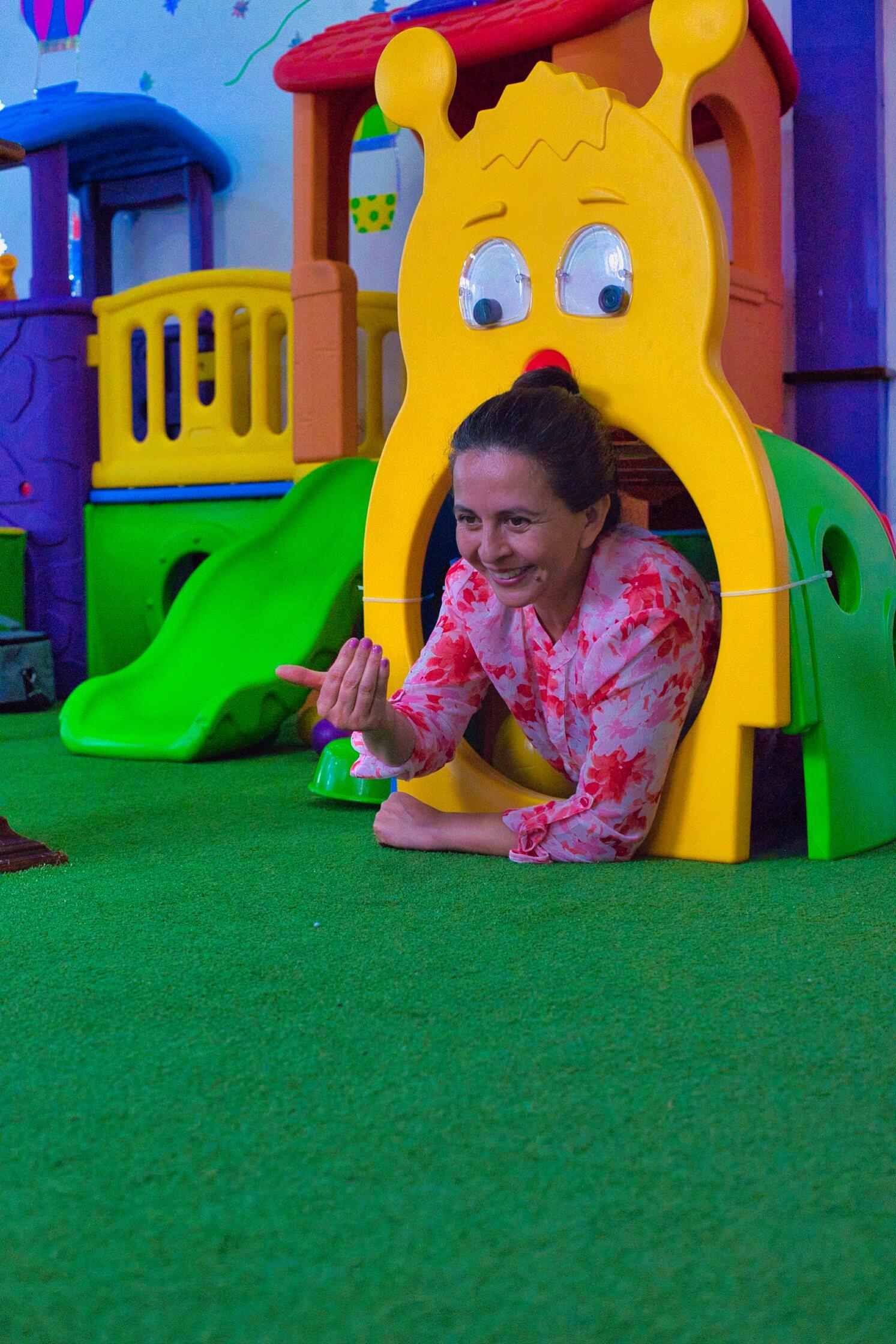 A therapist using a playful activity to target strength and coordination goals.